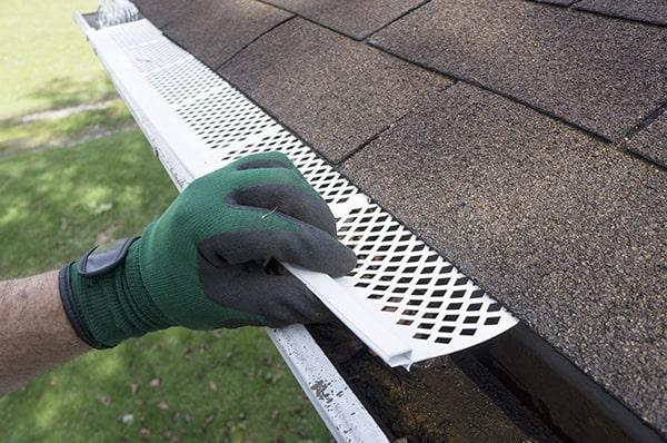 gutter guards work by creating a barrier that allows water to flow through while blocking debris